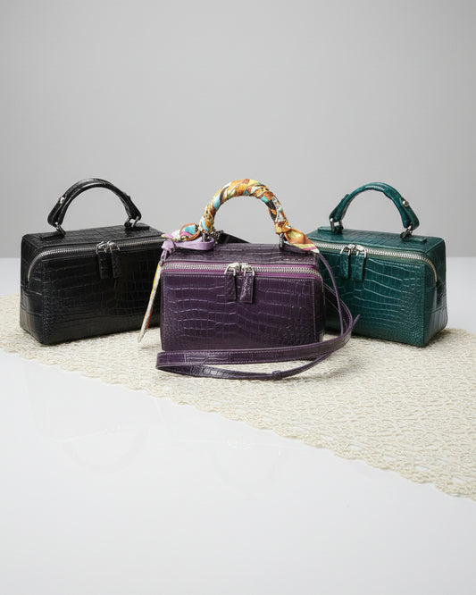 Collection of handbags on a table with a patterned tablecloth