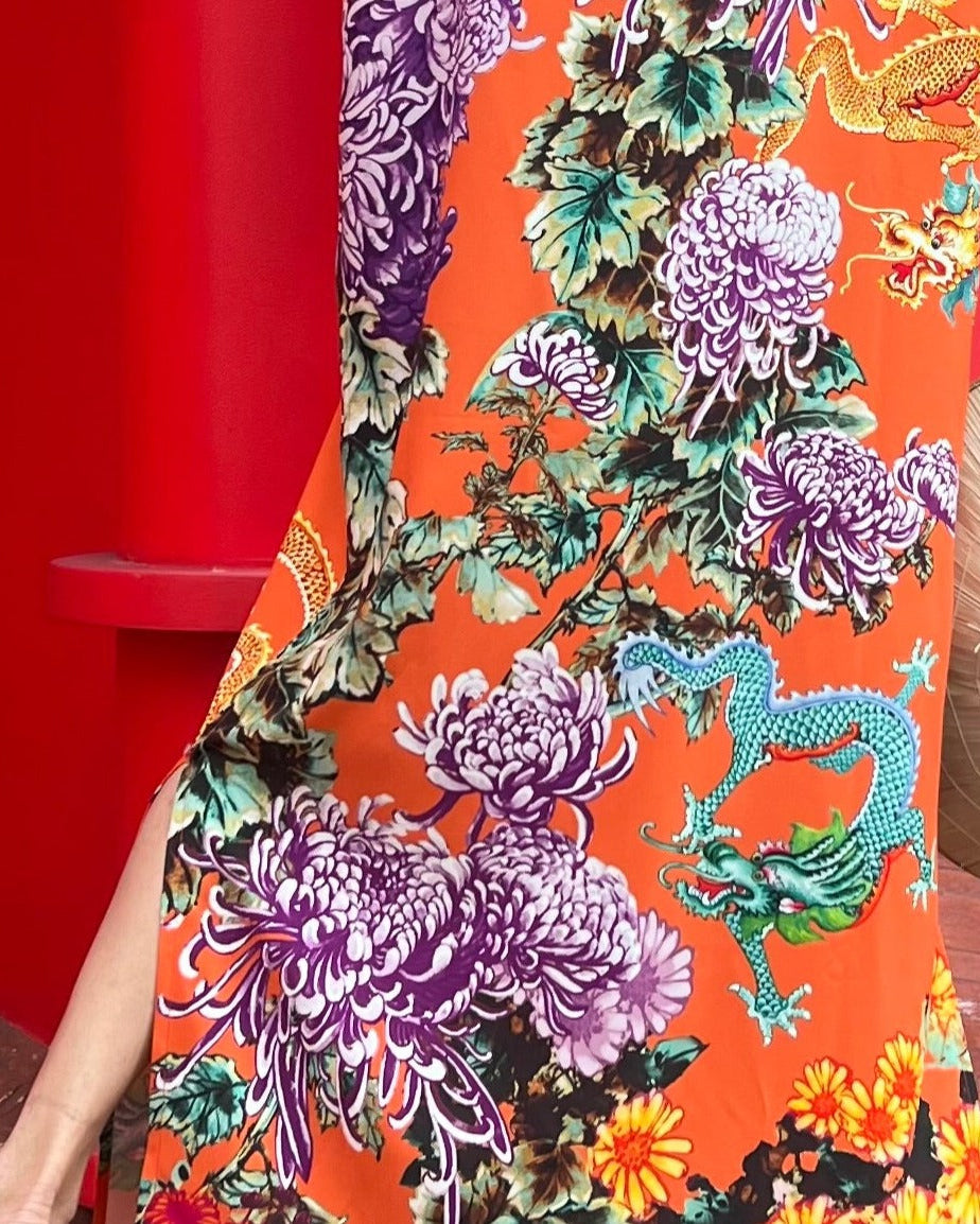 Colorful fabric with floral and dragon design on a red background