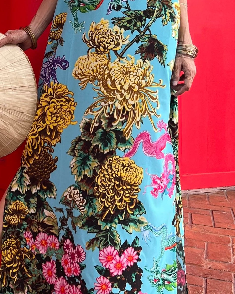 Close-up of a colorful floral dress with intricate patterns on a red background
