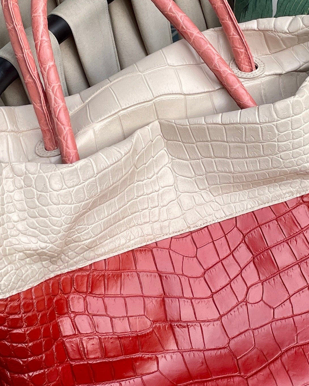 Tote bag with red and beige design on a patterned chair